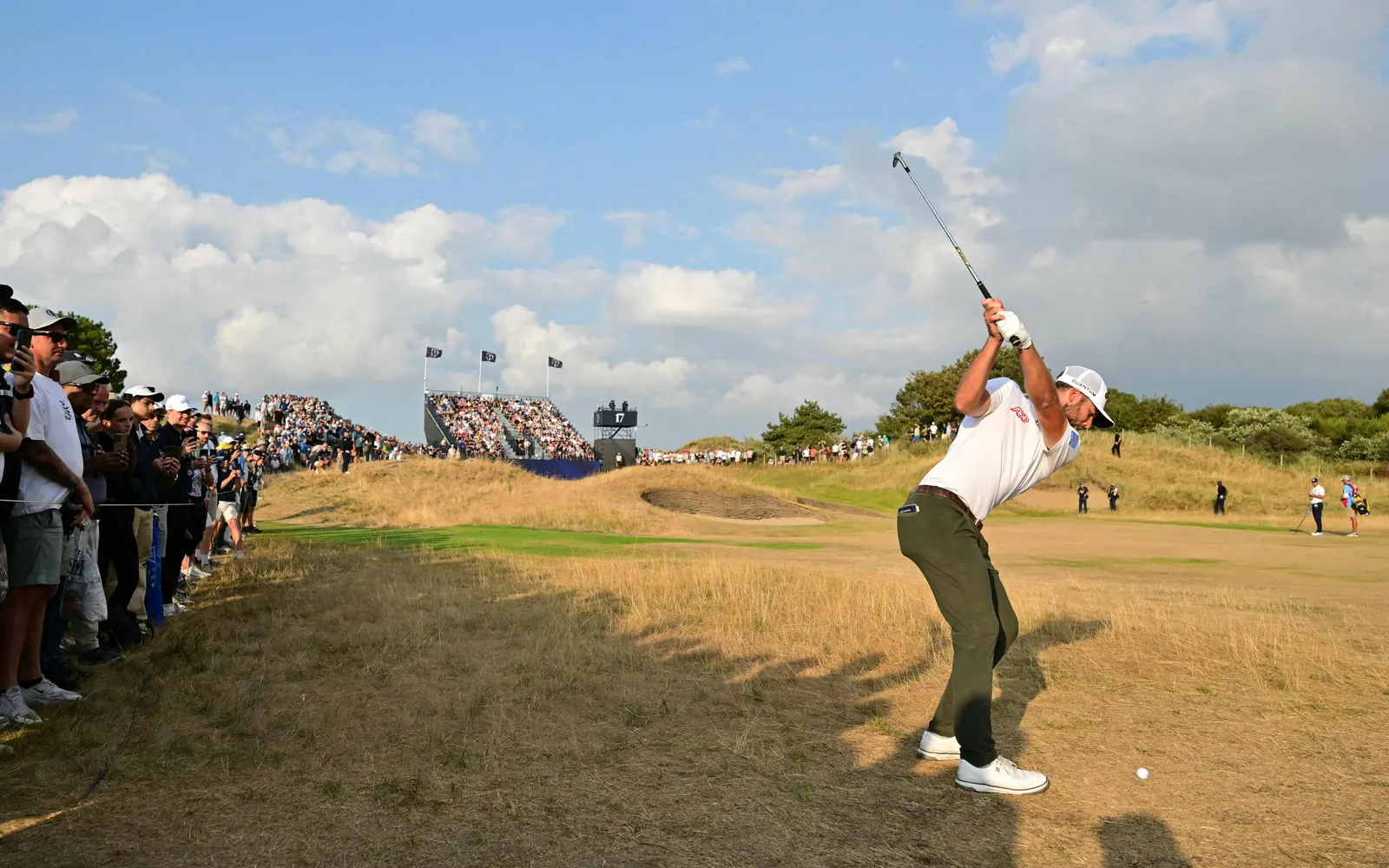 US golfer Sam Burns plays his approach shot from the 17th fairway on day three of the 154th Open Golf championship at Royal Birkdale Golf Club near Southport in north-west England on July 18, 2026. (Photo by ANDY BUCHANAN / AFP) / RESTRICTED TO EDITORIAL USE